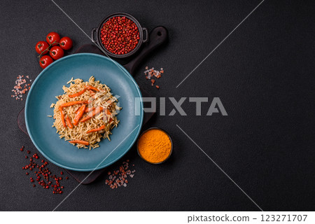 Delicious fresh pilaf with rice, carrots, meat, onions, spices and berries Delicious fresh pilaf with rice, carrots, meat, onions, spices and berries 123271707
