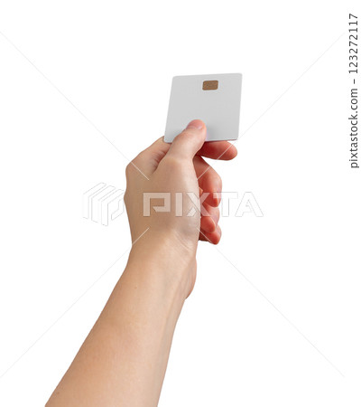 Female hand holding a blank credit card at an angle, showcasing payment, transfer, and commerce 123272117