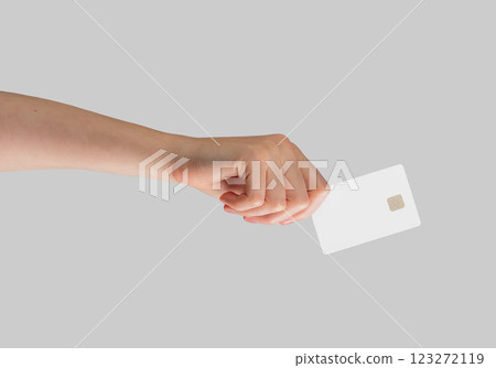 Female hand holding a blank credit card, ideal for showcasing advertising, promotions, and financial 123272119