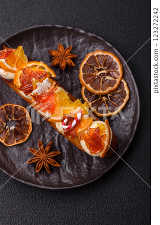 Delicious sweet eclair with chocolate filling, covered with cream Delicious sweet eclair with chocolate filling, covered with cream 123272242