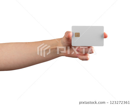 Female hand holding a credit card with a chip, showcasing it for payment, promotion, or financial 123272361