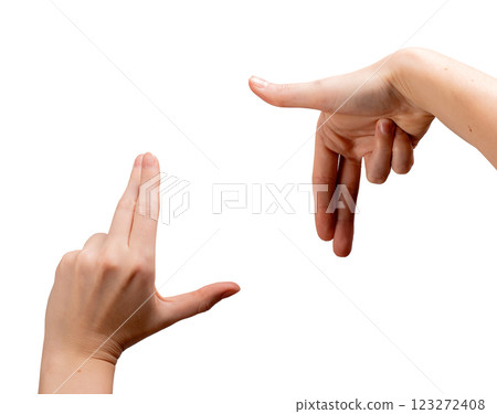 Female hands forming an L-shaped framing gesture, thumbs and index fingers creating a square to Female hands forming an L-shaped framing gesture, thumbs and index fingers creating a square to 123272408