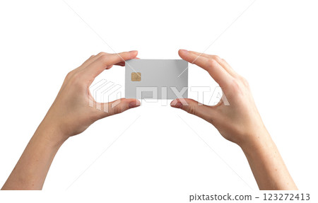Female hands holding a credit card with a chip, showcasing it for payment or promotion. Isolated on 123272413