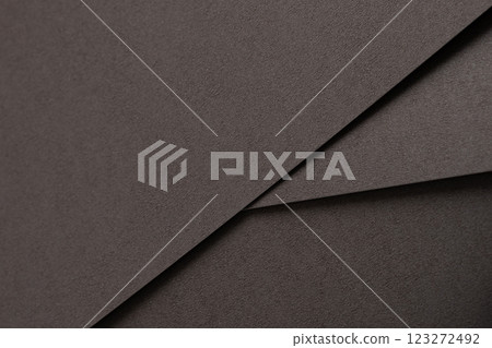 Dark espresso brown paper background with a smooth matte texture and subtle geometric lines. Rich 123272492