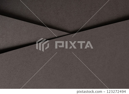 Dark espresso brown paper background with a smooth matte texture and subtle geometric lines. Rich 123272494