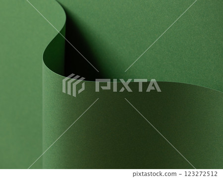 Deep forest green paper background with a smooth matte texture and layered, wavy folds. Rich moss 123272512