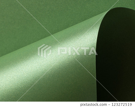Deep forest green paper background with a smooth matte texture and subtle wavy edges. Rich basil and 123272519