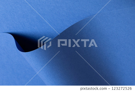Deep sapphire blue paper background with a smooth texture and overlapping curved folds. Vibrant 123272526