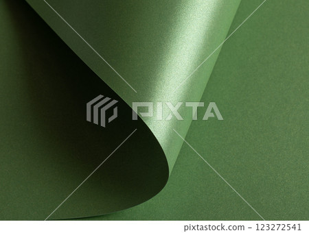 green paper background with a pearlescent, glossy texture and shimmering wavy edges. Deep forest and green paper background with a pearlescent, glossy texture and shimmering wavy edges. Deep forest and 123272541