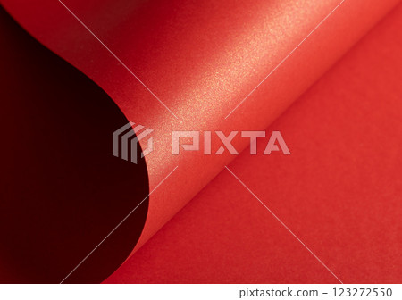 Fiery crimson paper background with a pearlescent, glossy texture and shimmering waves. Rich scarlet 123272550