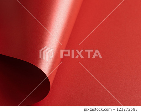 Fiery scarlet paper background with a pearlescent, glossy texture and shimmering wavy edges. Rich Fiery scarlet paper background with a pearlescent, glossy texture and shimmering wavy edges. Rich 123272585