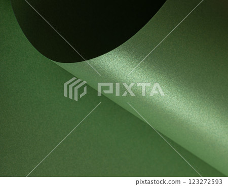 Forest green paper background with a pearlescent, glossy texture and shimmering wavy edges. Rich Forest green paper background with a pearlescent, glossy texture and shimmering wavy edges. Rich 123272593