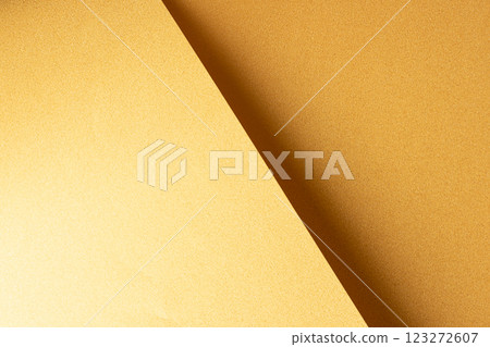 Golden saffron paper background with a pearlescent, glossy texture and shimmering reflections. 123272607