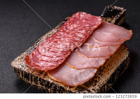 Delicious fresh smoked sausages cut with slices Delicious fresh smoked sausages cut with slices 123272659