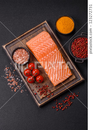 Fresh raw salmon steak with spices and herbs Fresh raw salmon steak with spices and herbs 123272731