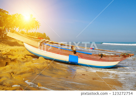 Untouched tropical beach with palms and fishing boats in Sri-Lanka Untouched tropical beach with palms and fishing boats in Sri-Lanka 123272754