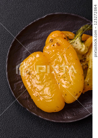 Yellow sweet pepper cut in half and grilled with salt, spices and herbs 123272864