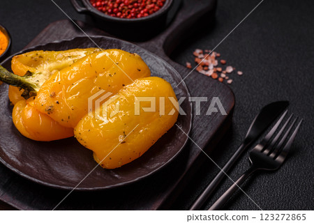 Yellow sweet pepper cut in half and grilled with salt, spices and herbs Yellow sweet pepper cut in half and grilled with salt, spices and herbs 123272865