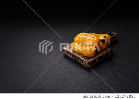 Yellow sweet pepper cut in half and grilled with salt, spices and herbs Yellow sweet pepper cut in half and grilled with salt, spices and herbs 123272883