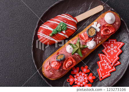 Sweet eclair with chocolate filling, decorated for Christmas Sweet eclair with chocolate filling, decorated for Christmas 123273106