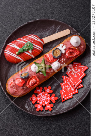 Sweet eclair with chocolate filling, decorated for Christmas Sweet eclair with chocolate filling, decorated for Christmas 123273107