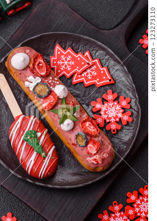 Sweet eclair with chocolate filling, decorated for Christmas Sweet eclair with chocolate filling, decorated for Christmas 123273110