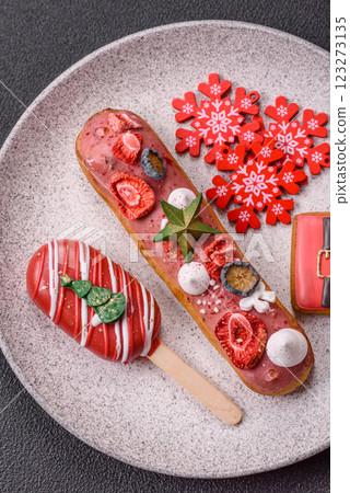 Sweet eclair with chocolate filling, decorated for Christmas 123273135