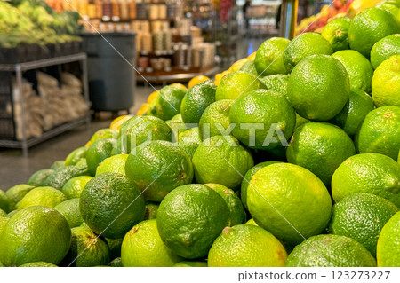 fresh, bright green limes stacked in the produce section of a grocery store fresh, bright green limes stacked in the produce section of a grocery store 123273227