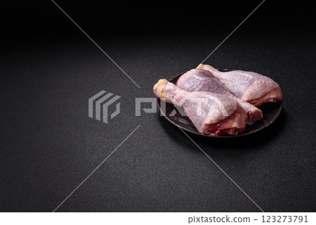 Raw chicken or turkey legs with salt, spices and herbs 123273791