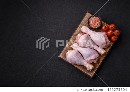 Raw chicken or turkey legs with salt, spices and herbs 123273804