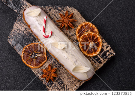 Sweet eclair with chocolate filling covered with white glaze 123273835