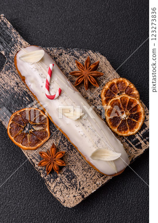 Sweet eclair with chocolate filling covered with white glaze 123273836