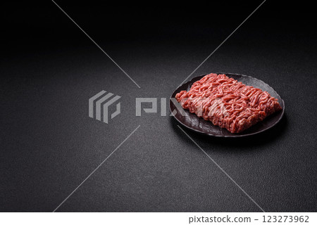 Fresh raw ground minced beef with salt and spices 123273962