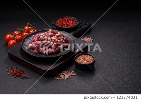 Raw chicken hearts with salt, spices and herbs Raw chicken hearts with salt, spices and herbs 123274031