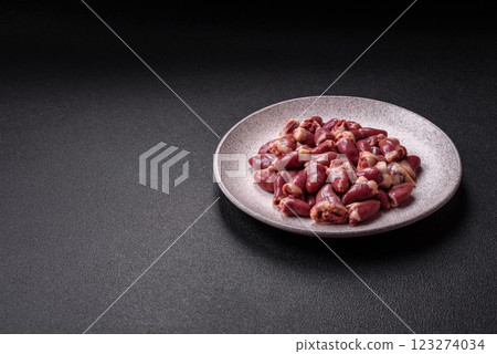 Raw chicken hearts with salt, spices and herbs Raw chicken hearts with salt, spices and herbs 123274034