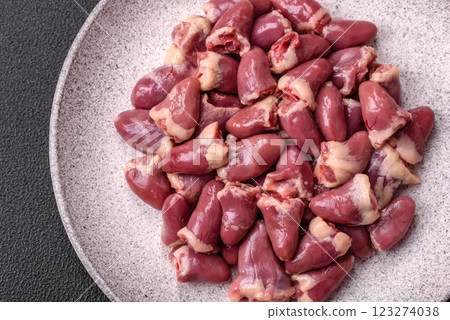 Raw chicken hearts with salt, spices and herbs Raw chicken hearts with salt, spices and herbs 123274038