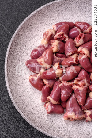 Raw chicken hearts with salt, spices and herbs Raw chicken hearts with salt, spices and herbs 123274039