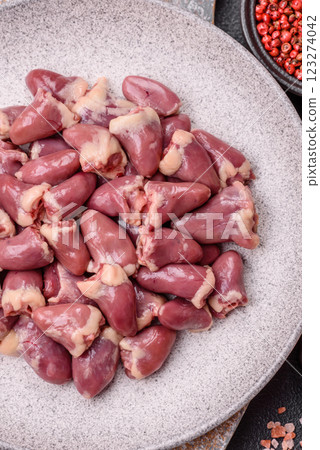 Raw chicken hearts with salt, spices and herbs Raw chicken hearts with salt, spices and herbs 123274042