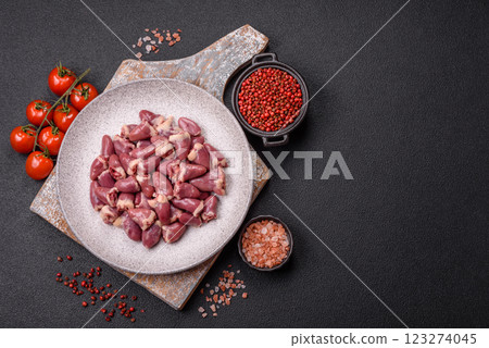 Raw chicken hearts with salt, spices and herbs 123274045