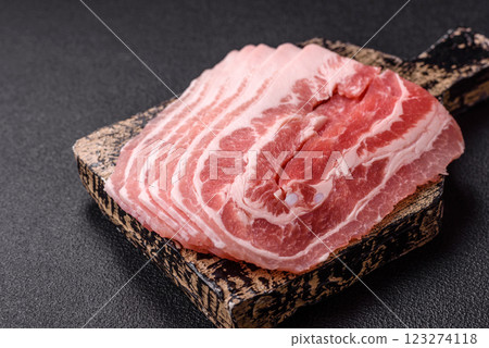 Fresh raw bacon sliced with spices and herbs Fresh raw bacon sliced with spices and herbs 123274118