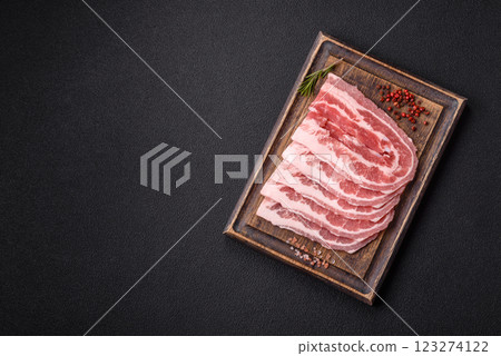 Fresh raw bacon sliced with spices and herbs Fresh raw bacon sliced with spices and herbs 123274122