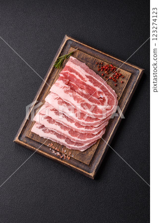 Fresh raw bacon sliced with spices and herbs Fresh raw bacon sliced with spices and herbs 123274123