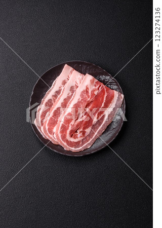 Fresh raw bacon sliced with spices and herbs Fresh raw bacon sliced with spices and herbs 123274136