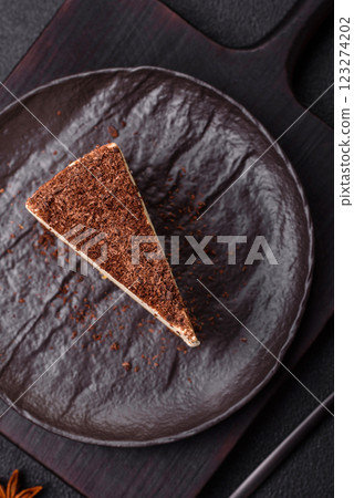 Slice of sweet cheesecake sprinkled with chopped chocolate Slice of sweet cheesecake sprinkled with chopped chocolate 123274202