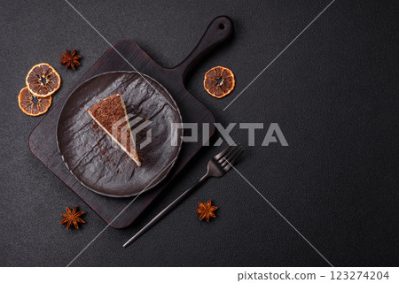 Slice of sweet cheesecake sprinkled with chopped chocolate Slice of sweet cheesecake sprinkled with chopped chocolate 123274204