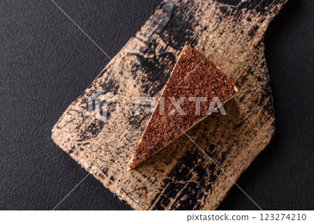 Slice of sweet cheesecake sprinkled with chopped chocolate 123274210