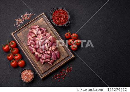 Raw chicken hearts with salt, spices and herbs 123274222