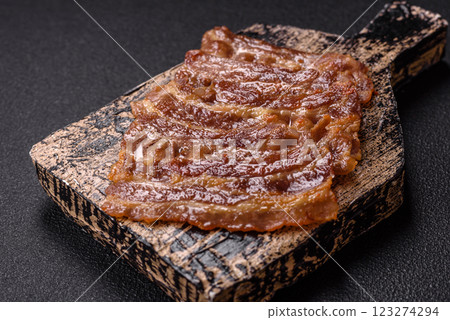Crispy fried pork bacon sliced with salt, spices and herbs Crispy fried pork bacon sliced with salt, spices and herbs 123274294