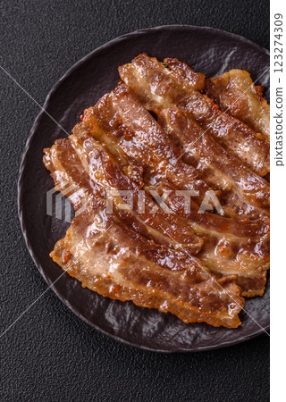 Crispy fried pork bacon sliced with salt, spices and herbs 123274309
