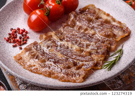 Crispy fried pork bacon sliced with salt, spices and herbs Crispy fried pork bacon sliced with salt, spices and herbs 123274319
